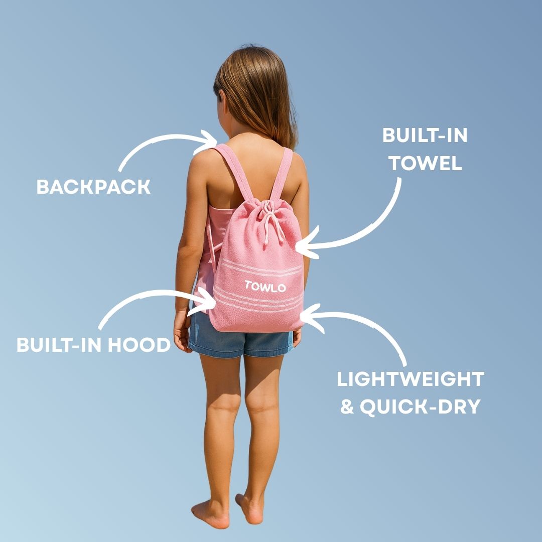 Girl wearing a pink Towlo kids hooded towel backpack, showing built-in towel, built-in hood, lightweight quick-dry design and multi-purpose backpack function.