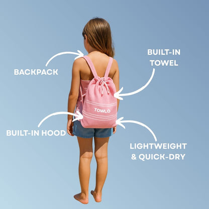 Girl wearing a pink Towlo kids hooded towel backpack, showing built-in towel, built-in hood, lightweight quick-dry design and multi-purpose backpack function.